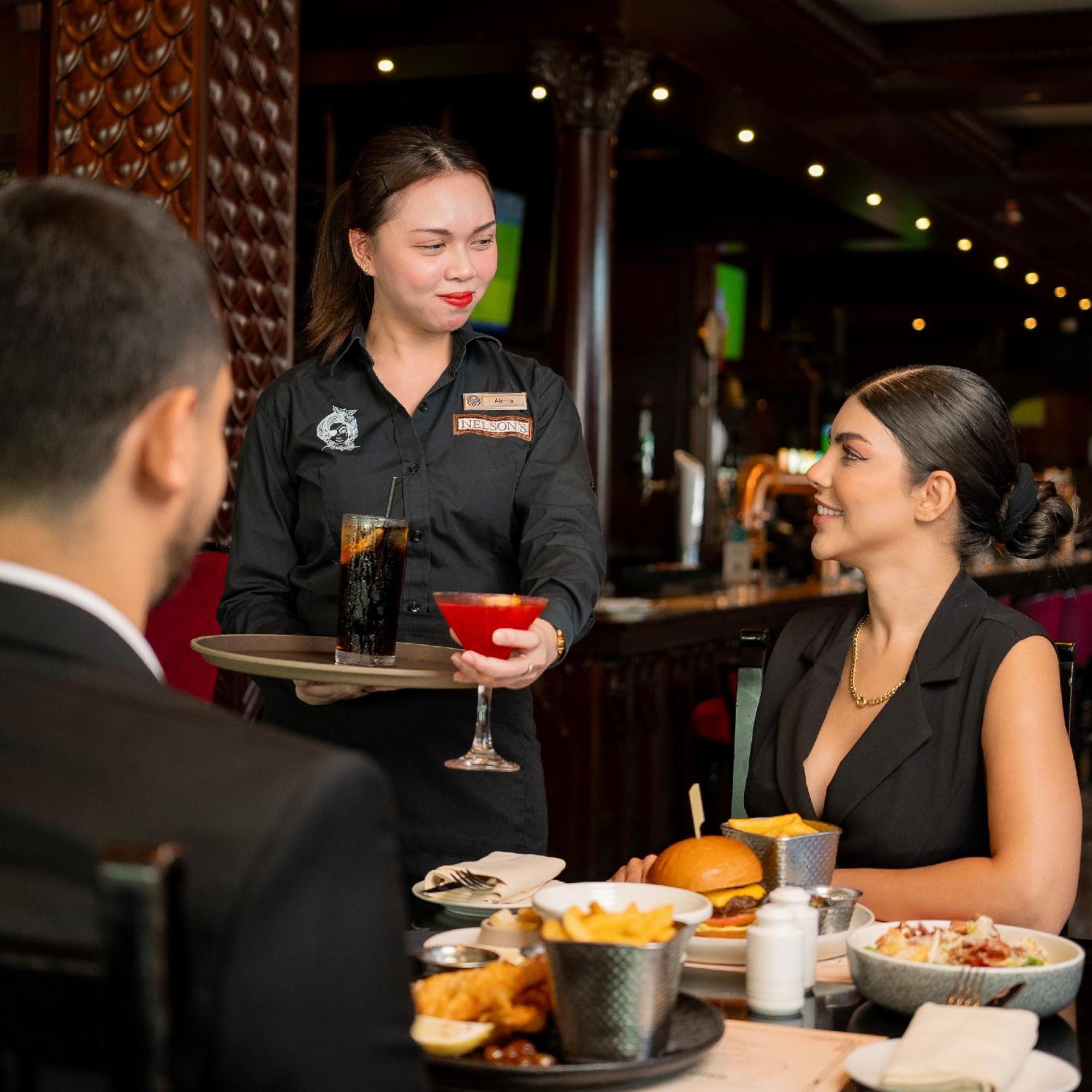 Отель Media Rotana Дубай Экстерьер фото A waitress serving drinks